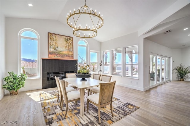 1144 Calico Ridge Dr, Henderson, NV 89011 - dining area with vaulted ceiling, wood finished floors, a chandelier, plenty of natural light, and recessed lighting