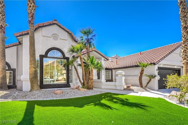 1144 Calico Ridge Dr, Henderson, NV 89011 - mediterranean / spanish house featuring stucco siding, a tile roof, an attached garage, and a front lawn