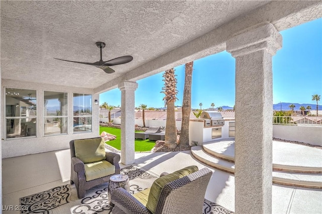 1144 Calico Ridge Dr, Henderson, NV 89011 - fenced backyard with a patio, area for grilling, ceiling fan, and a residential view