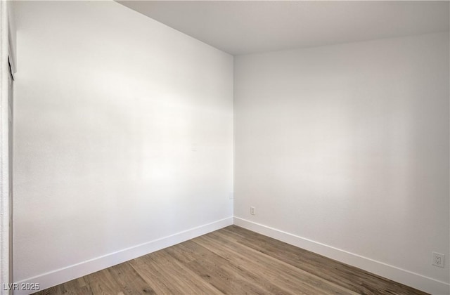 1144 Calico Ridge Dr, Henderson, NV 89011 - spare room featuring baseboards and wood finished floors