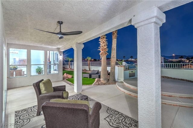 1144 Calico Ridge Dr, Henderson, NV 89011 - patio at night with ceiling fan, a patio area, and area for grilling