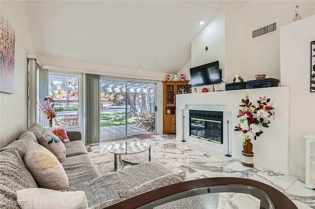 7068 Bright Springs Ct, Las Vegas, NV 89113 - living room with light marble finish flooring, high vaulted ceiling, and a glass covered fireplace