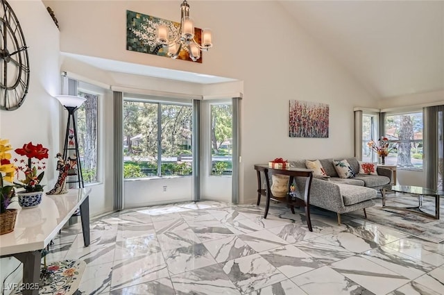 7068 Bright Springs Ct, Las Vegas, NV 89113 - living room featuring high vaulted ceiling, healthy amount of natural light, a chandelier, and light marble finish floors