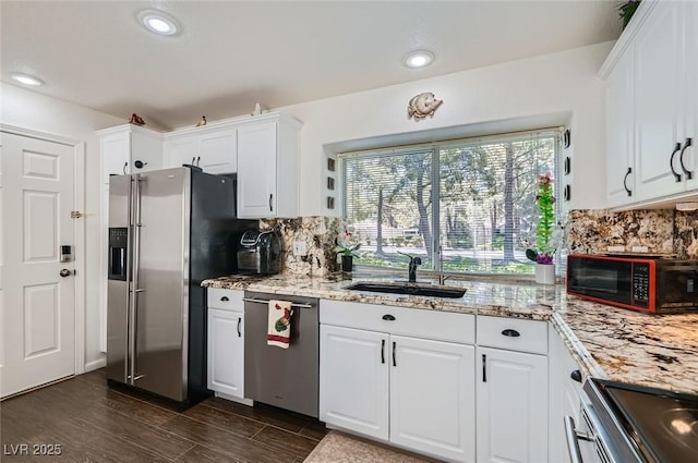 7068 Bright Springs Ct, Las Vegas, NV 89113 - kitchen with appliances with stainless steel finishes, white cabinets, tasteful backsplash, light stone counters, and recessed lighting