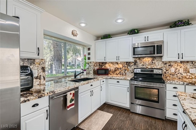 7068 Bright Springs Ct, Las Vegas, NV 89113 - kitchen featuring stainless steel appliances, white cabinets, decorative backsplash, and recessed lighting