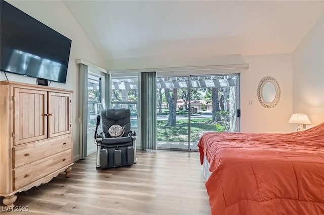 7068 Bright Springs Ct, Las Vegas, NV 89113 - bedroom featuring access to outside, wood finished floors, vaulted ceiling, and multiple windows