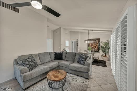 2135 Hallston St, Las Vegas, NV 89134 - living area with a ceiling fan, a chandelier, lofted ceiling, and light tile patterned floors