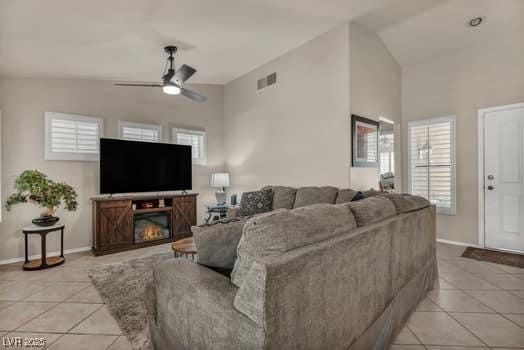 2135 Hallston St, Las Vegas, NV 89134 - living room with light tile patterned floors, lofted ceiling, a ceiling fan, and plenty of natural light