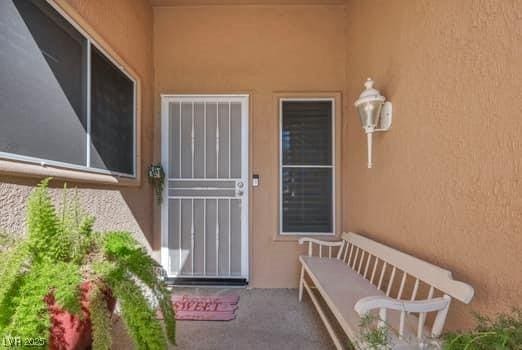 2135 Hallston St, Las Vegas, NV 89134 - doorway to property with stucco siding
