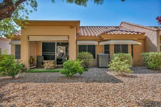 2135 Hallston St, Las Vegas, NV 89134 - rear view of house with a tile roof and stucco siding