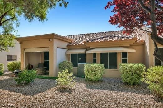 2135 Hallston St, Las Vegas, NV 89134 - back of property with stucco siding and a tiled roof