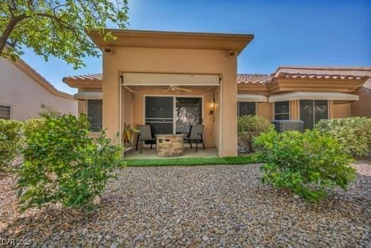 2135 Hallston St, Las Vegas, NV 89134 - back of property with a patio, stucco siding, a tiled roof, and ceiling fan