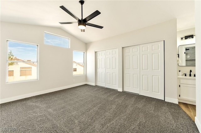 1724 Navajo Lake Way, Las Vegas, NV 89128 - unfurnished bedroom featuring two closets, vaulted ceiling, dark carpet, and ceiling fan