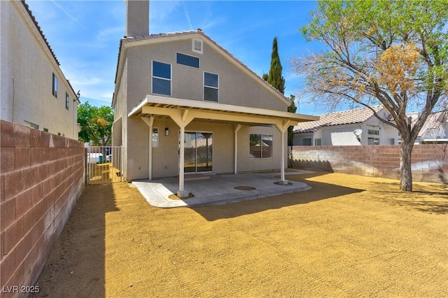 1724 Navajo Lake Way, Las Vegas, NV 89128 - rear view of house with a patio, stucco siding, a fenced backyard, and a chimney