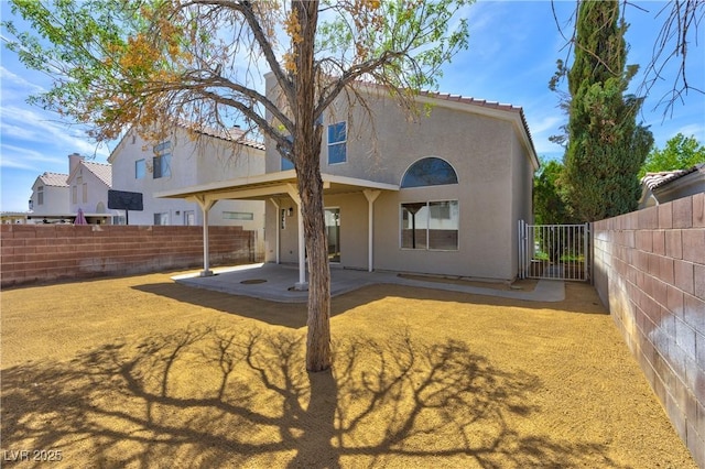 1724 Navajo Lake Way, Las Vegas, NV 89128 - back of house featuring a patio, stucco siding, and a fenced backyard
