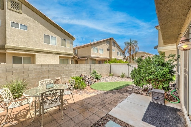 6068 Shyley St Unit 102, Henderson, NV 89011 - fenced backyard featuring a patio area and outdoor dining space