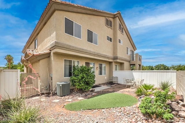 6068 Shyley St Unit 102, Henderson, NV 89011 - back of property with stucco siding, a tiled roof, a fenced backyard, and a patio