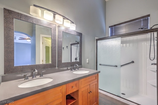 6068 Shyley St Unit 102, Henderson, NV 89011 - bathroom featuring a stall shower, double vanity, and a ceiling fan