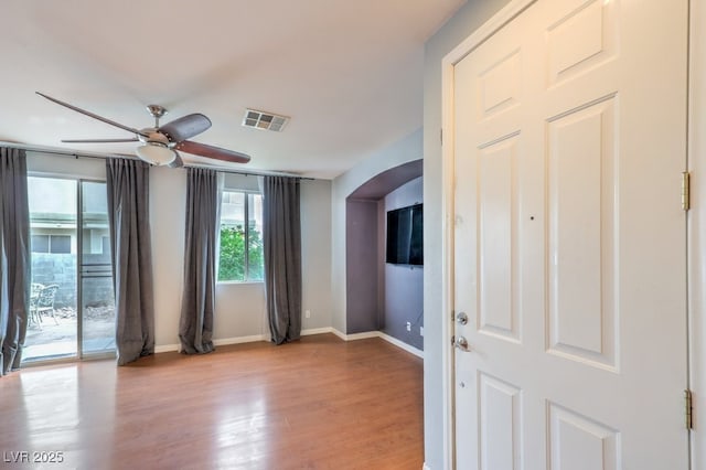 6068 Shyley St Unit 102, Henderson, NV 89011 - unfurnished room with arched walkways, a ceiling fan, and light wood finished floors