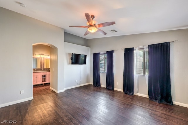 6068 Shyley St Unit 102, Henderson, NV 89011 - empty room with arched walkways, a ceiling fan, a smoke detector, wood finished floors, and vaulted ceiling