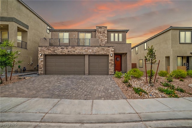 10189 Magnolia Creek St, Las Vegas, NV 89141 - view of front of property featuring a balcony, decorative driveway, stucco siding, and stone siding