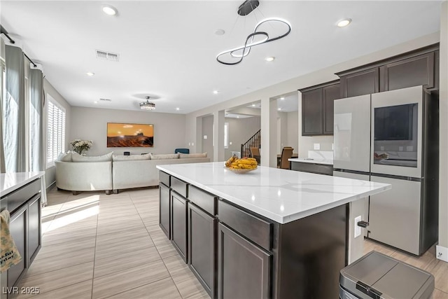 10189 Magnolia Creek St, Las Vegas, NV 89141 - kitchen with fridge, dark brown cabinets, open floor plan, a kitchen island, and recessed lighting