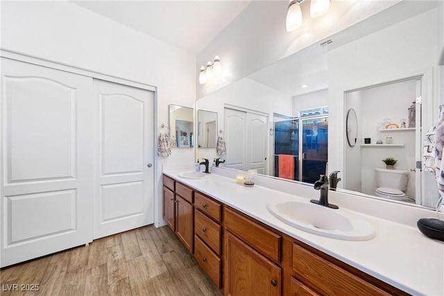 5520 Carrara Pointe St, Pahrump, NV 89061 - full bathroom with double vanity, a stall shower, and wood finished floors