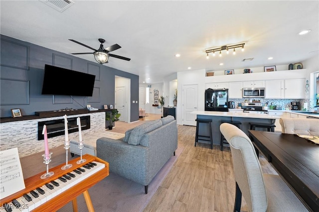 5520 Carrara Pointe St, Pahrump, NV 89061 - living area with ceiling fan and light wood-style flooring