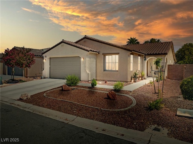 5520 Carrara Pointe St, Pahrump, NV 89061 - mediterranean / spanish-style home featuring stucco siding, a tiled roof, concrete driveway, and an attached garage