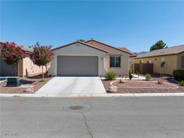 5520 Carrara Pointe St, Pahrump, NV 89061 - mediterranean / spanish-style house featuring a garage, driveway, stucco siding, and a tiled roof
