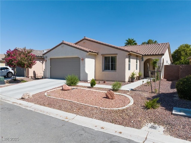5520 Carrara Pointe St, Pahrump, NV 89061 - mediterranean / spanish-style house featuring stucco siding, a tiled roof, concrete driveway, and a garage