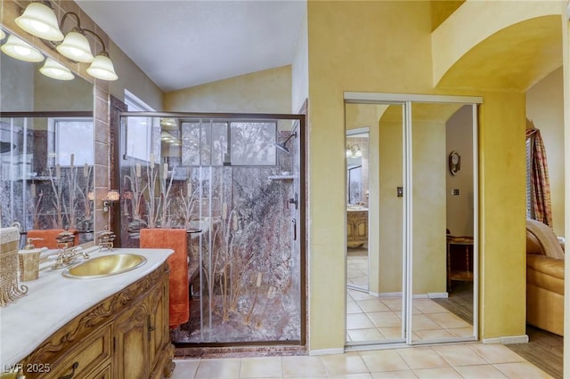 7721 Beach Falls Ct, Las Vegas, NV 89149 - full bath featuring vanity, vaulted ceiling, a shower stall, and tile patterned flooring
