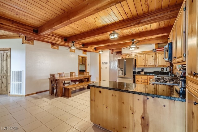 7790 Scottie St, Las Vegas, NV 89166 - kitchen with appliances with stainless steel finishes, ceiling fan, a peninsula, a wooden ceiling with exposed beams, and light tile patterned floors