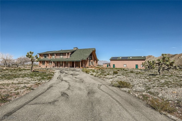 7790 Scottie St, Las Vegas, NV 89166 - log home featuring covered porch and asphalt driveway