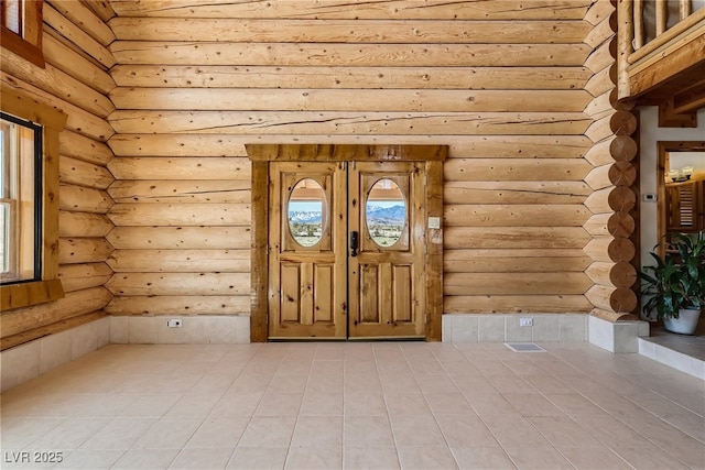 7790 Scottie St, Las Vegas, NV 89166 - entrance foyer with rustic walls and light tile patterned floors
