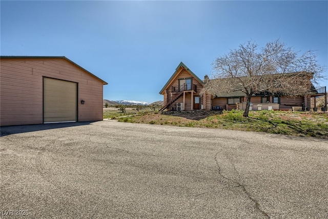 7790 Scottie St, Las Vegas, NV 89166 - view of front of home with an outbuilding, log siding, and a garage