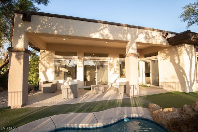 9 Knob Oak Dr, Henderson, NV 89052 - rear view of property featuring an area to practice putting, a patio area, and stucco siding