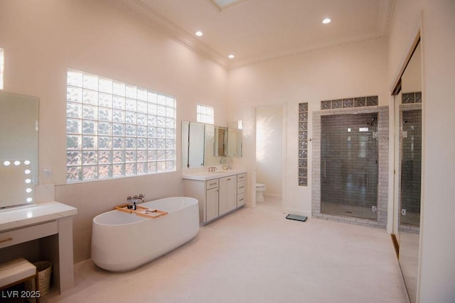 9 Knob Oak Dr, Henderson, NV 89052 - bathroom featuring a shower stall, crown molding, vanity, a freestanding bath, and recessed lighting