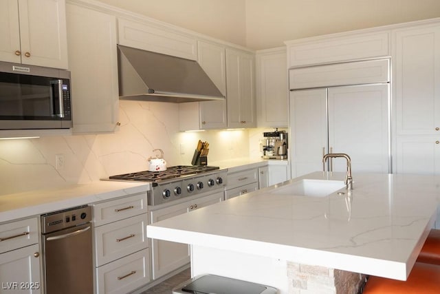 9 Knob Oak Dr, Henderson, NV 89052 - kitchen with exhaust hood, stainless steel appliances, tasteful backsplash, a kitchen island with sink, and light stone counters