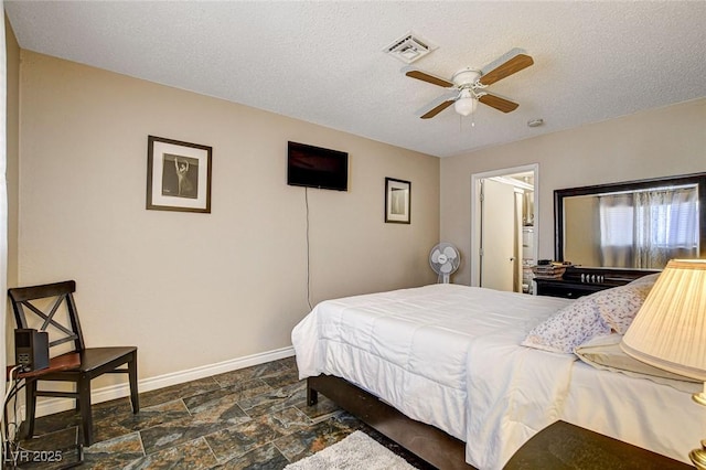 3912 Palos Verdes St, Las Vegas, NV 89119 - bedroom featuring dark stone finish flooring, a textured ceiling, and a ceiling fan