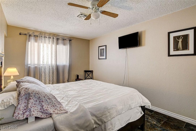 3912 Palos Verdes St, Las Vegas, NV 89119 - bedroom featuring a textured ceiling, a ceiling fan, a textured wall, and dark stone finish flooring