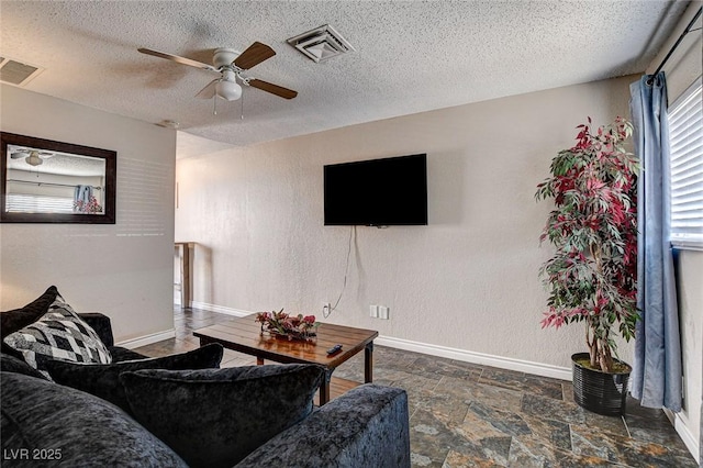 3912 Palos Verdes St, Las Vegas, NV 89119 - living room featuring a ceiling fan, a textured ceiling, and stone finish flooring
