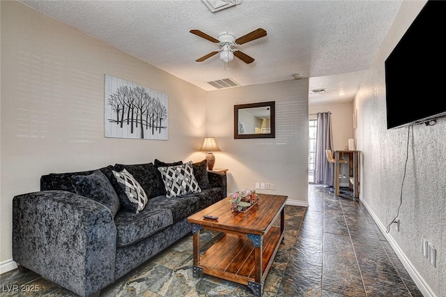 3912 Palos Verdes St, Las Vegas, NV 89119 - living room with stone tile floors, a ceiling fan, and a textured ceiling