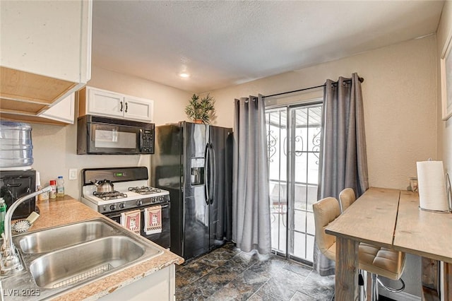 3912 Palos Verdes St, Las Vegas, NV 89119 - kitchen with black appliances, white cabinets, light countertops, and dark stone finish flooring