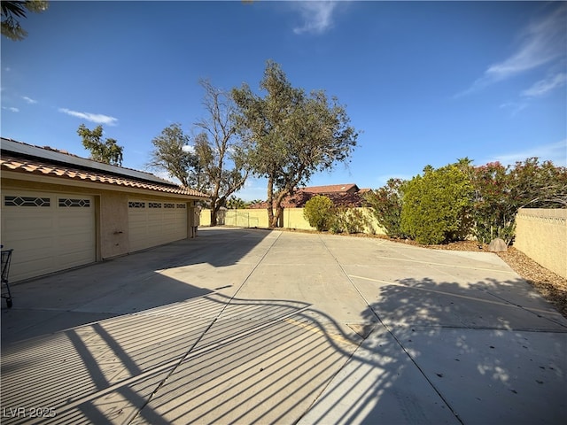2975 Montessouri St, Las Vegas, NV 89117 - view of patio with concrete driveway and a garage