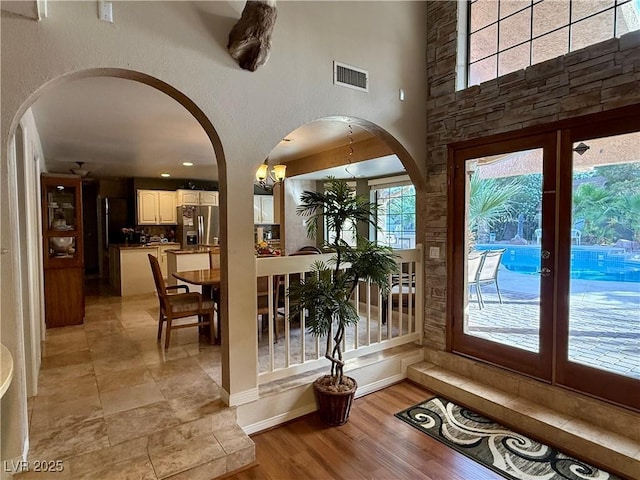2975 Montessouri St, Las Vegas, NV 89117 - foyer entrance with arched walkways, light wood-type flooring, and french doors