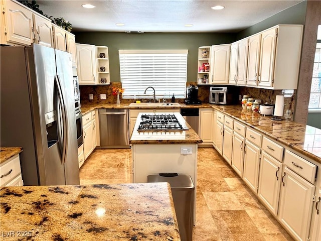 2975 Montessouri St, Las Vegas, NV 89117 - kitchen with appliances with stainless steel finishes, open shelves, tasteful backsplash, light stone counters, and recessed lighting