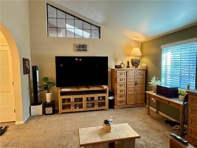 2975 Montessouri St, Las Vegas, NV 89117 - living room with arched walkways, carpet floors, and lofted ceiling