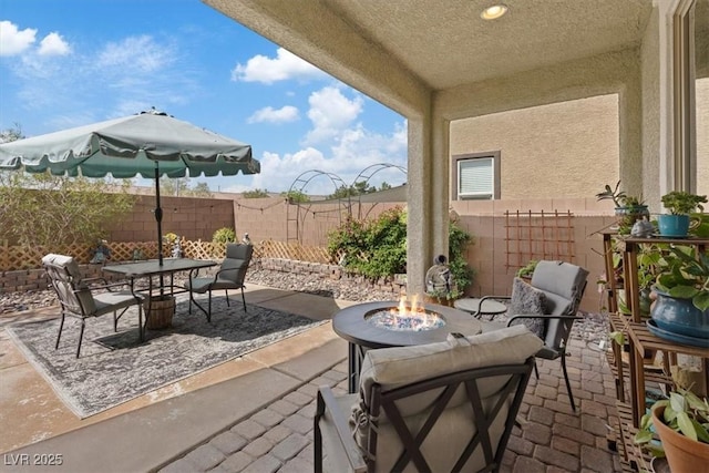 9305 Briar Bridge Ave, Las Vegas, NV 89148 - fenced backyard with an outdoor fire pit, a patio, and outdoor dining space