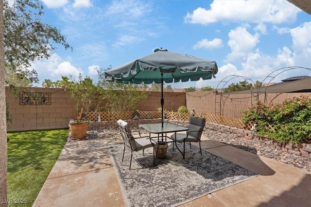 9305 Briar Bridge Ave, Las Vegas, NV 89148 - fenced backyard with outdoor dining space and a patio